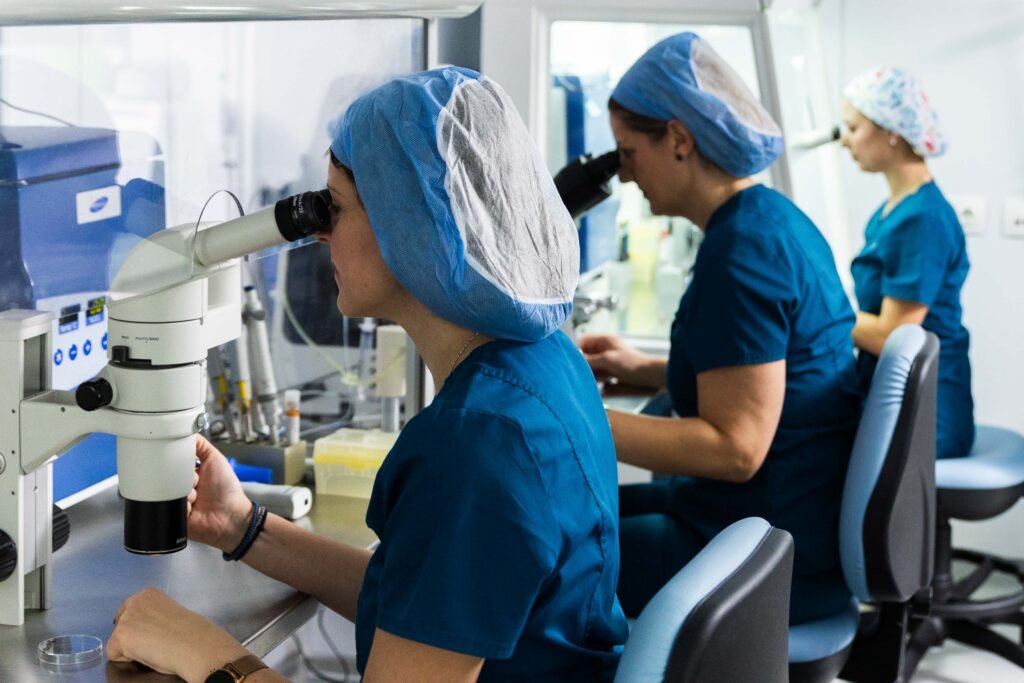 Three members of the Embryolab Clinic team in Thessaloniki are analyzing samples under the microscope